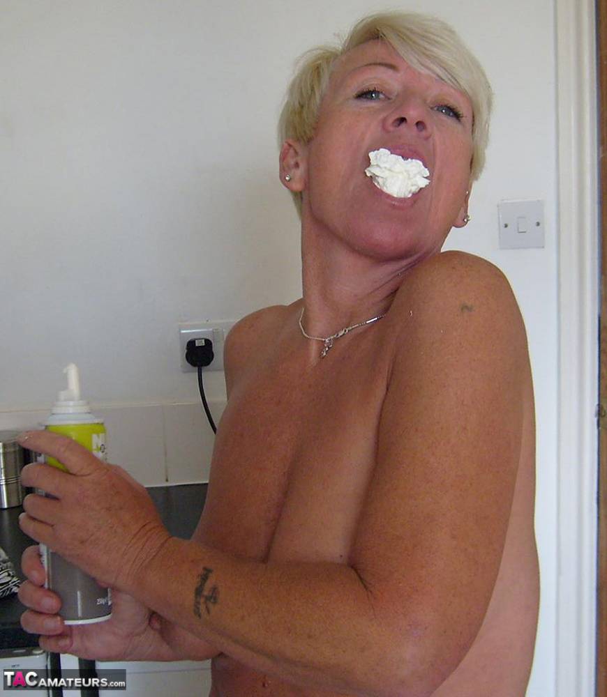 Older woman with short blonde hair Shazzy B covers her tits & twat in cream - #1