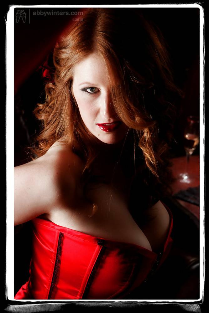 Busty redhead Chloe B assuming sexy solo poses in red corset and lingerie - #8