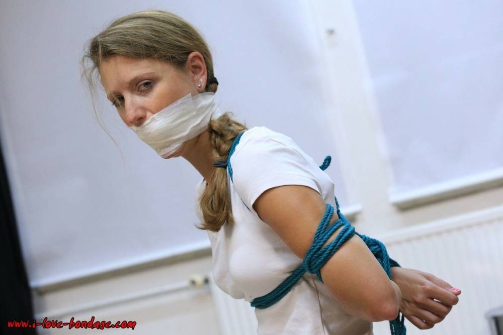 Clothed woman sports a pigtail while being gagged and tied up with rope - #4