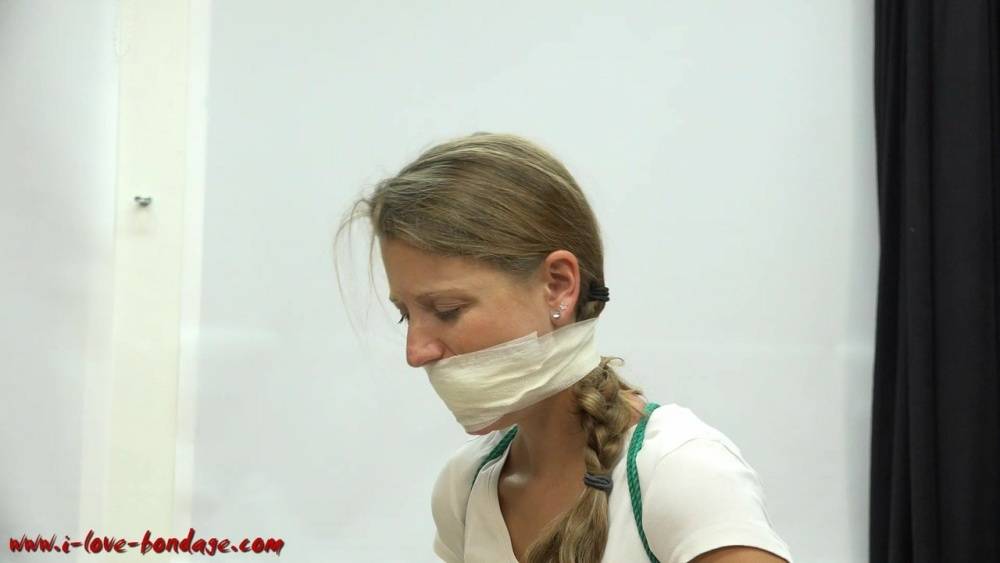 Clothed woman sports a pigtail while being gagged and tied up with rope - #11