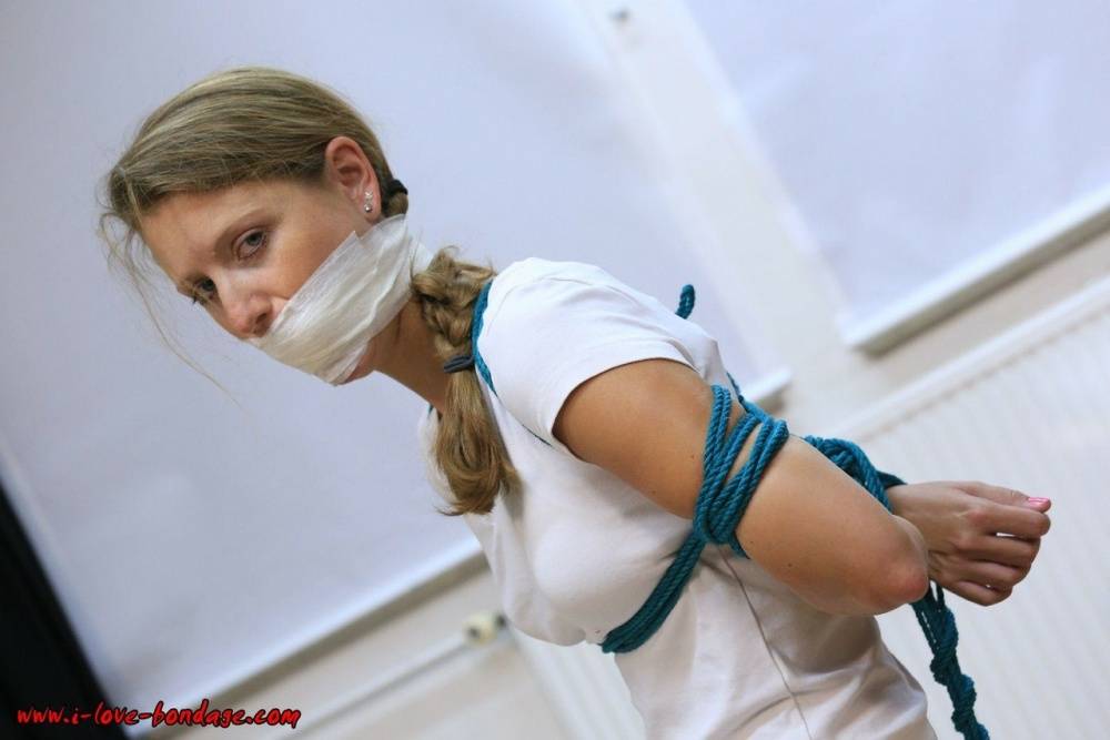 Clothed woman sports a pigtail while being gagged and tied up with rope - #6