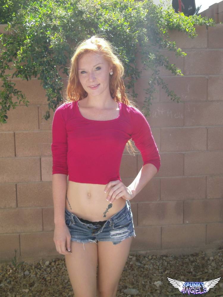 Hot redhead Alex Tanner flashes her tiny tits outdoors and drops her shorts - #6