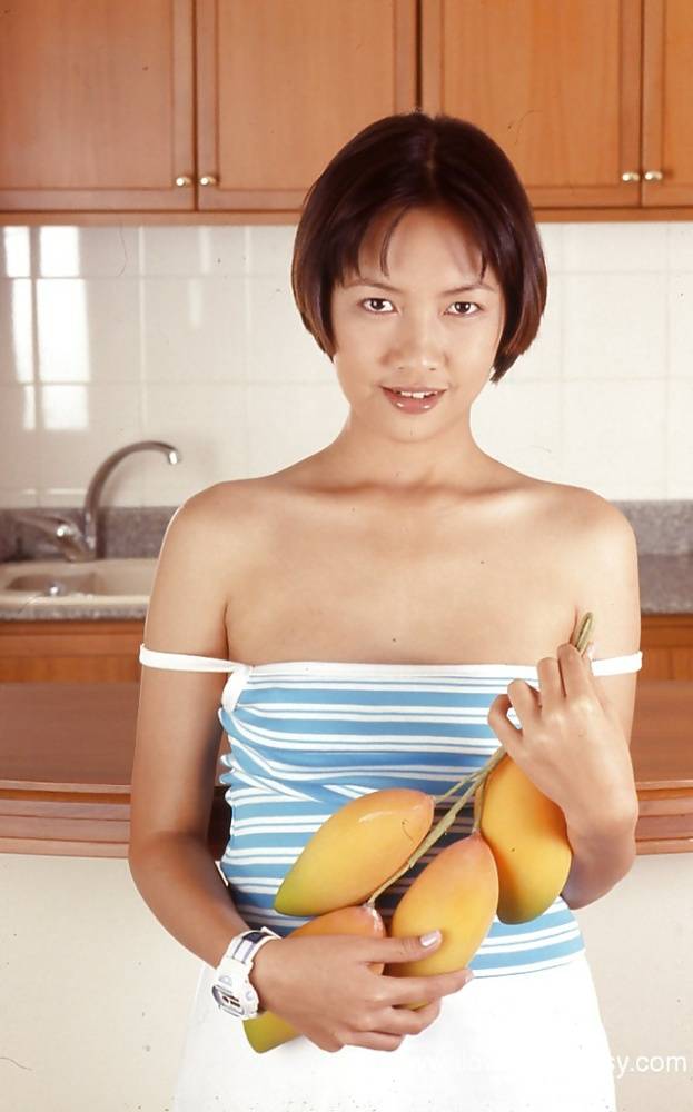 Clothed Asian with tiny tits is posing in the kitchen with spread legs - #9