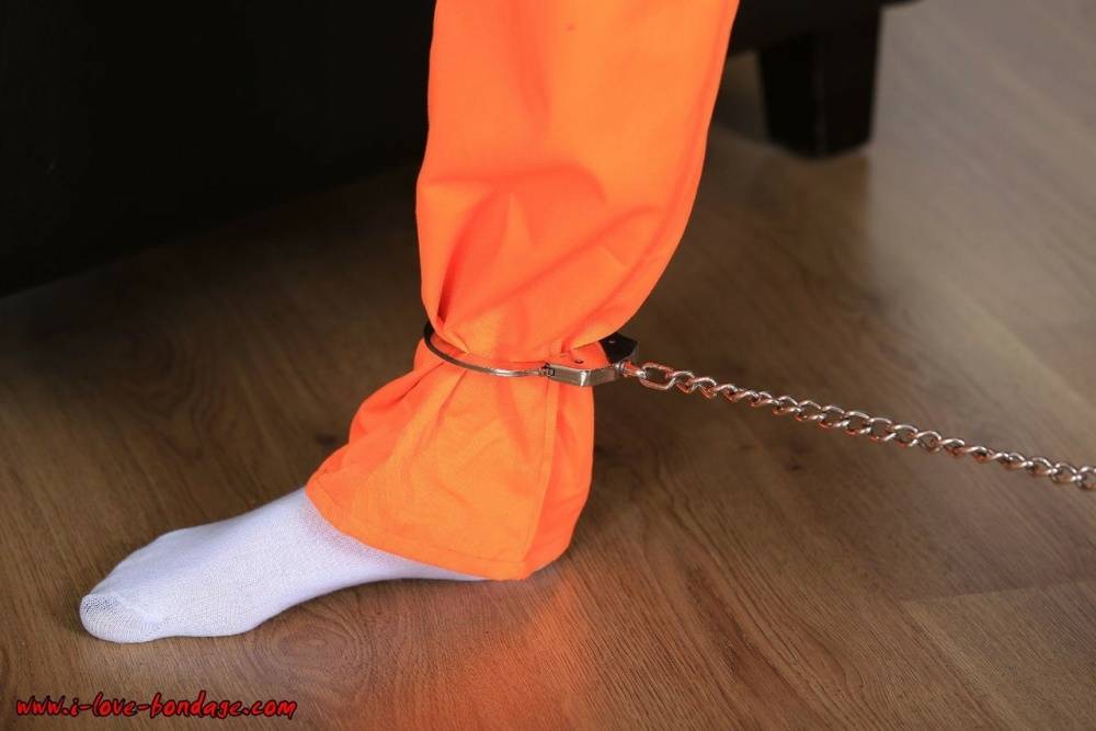 Female prisoner is left alone while cuffed in an orange jumper and white socks - #11