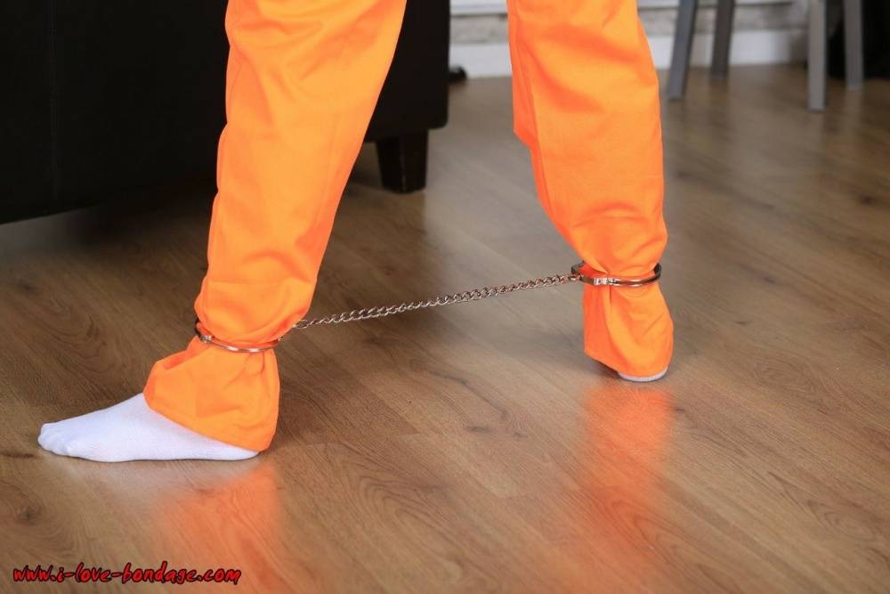 Female prisoner is left alone while cuffed in an orange jumper and white socks - #4