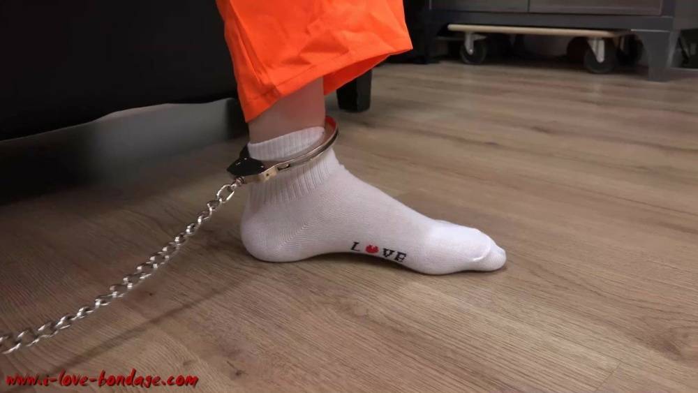 Female prisoner is left alone while cuffed in an orange jumper and white socks - #16