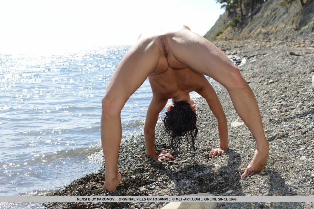 Flexible tiny titted Nensi B on the beach stretching to flaunt bald muff - #11
