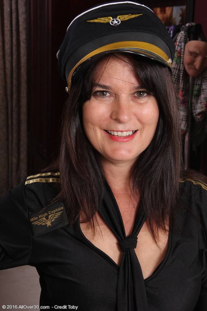 Mature woman Sherry Lee doffs pilot cap and uniform to model in the nude - #7
