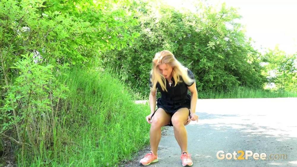Blonde Chrissy squats to take a pee in the middle of the walking path - #3