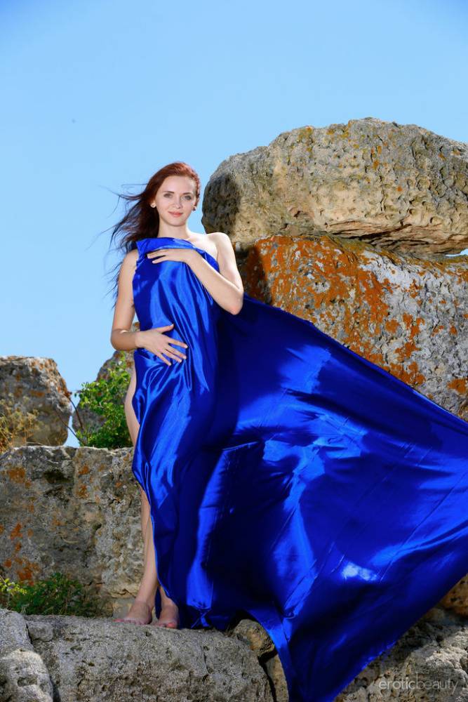 Young redhead Helena B models totally naked in a rocky location - #6