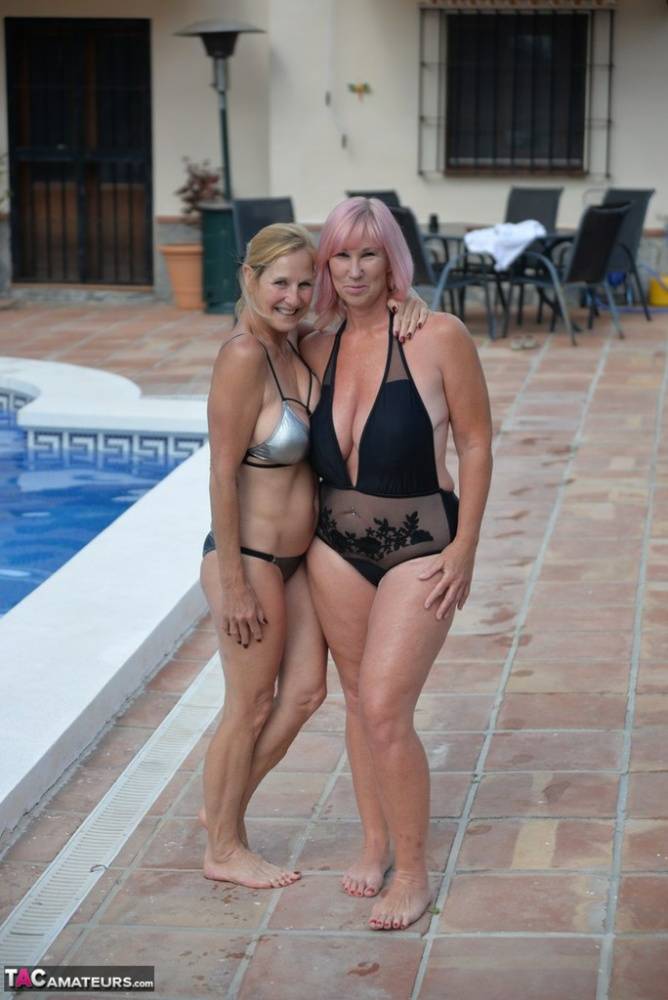 Mature amateurs share a lesbian kiss in their swimwear on poolside patio - #5