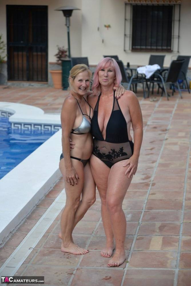 Mature amateurs share a lesbian kiss in their swimwear on poolside patio - #11