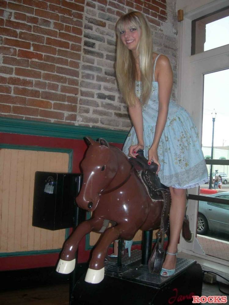 Blonde teen Jana Jordan licks an ice cream cone before straddling a toy horse - #11