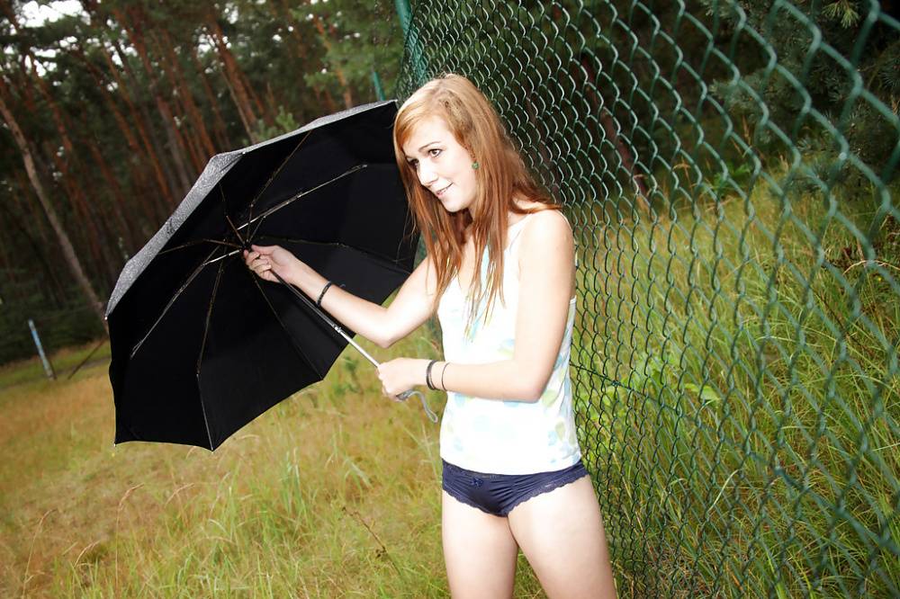 Lovely teen Anouk outdoors in the rain rubbing her smooth spread pussy - #8