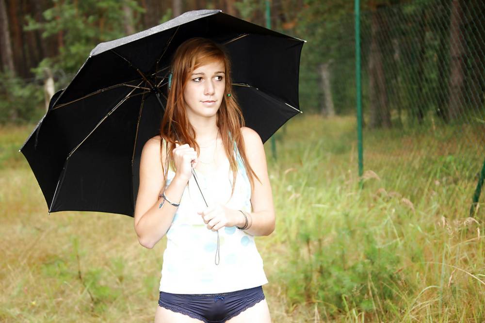 Lovely teen Anouk outdoors in the rain rubbing her smooth spread pussy - #10