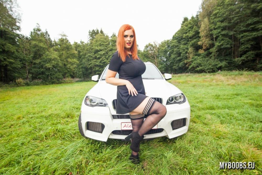 Redhead plumper Alexsis Faye sets her giant tits loose on a car in a field - #11