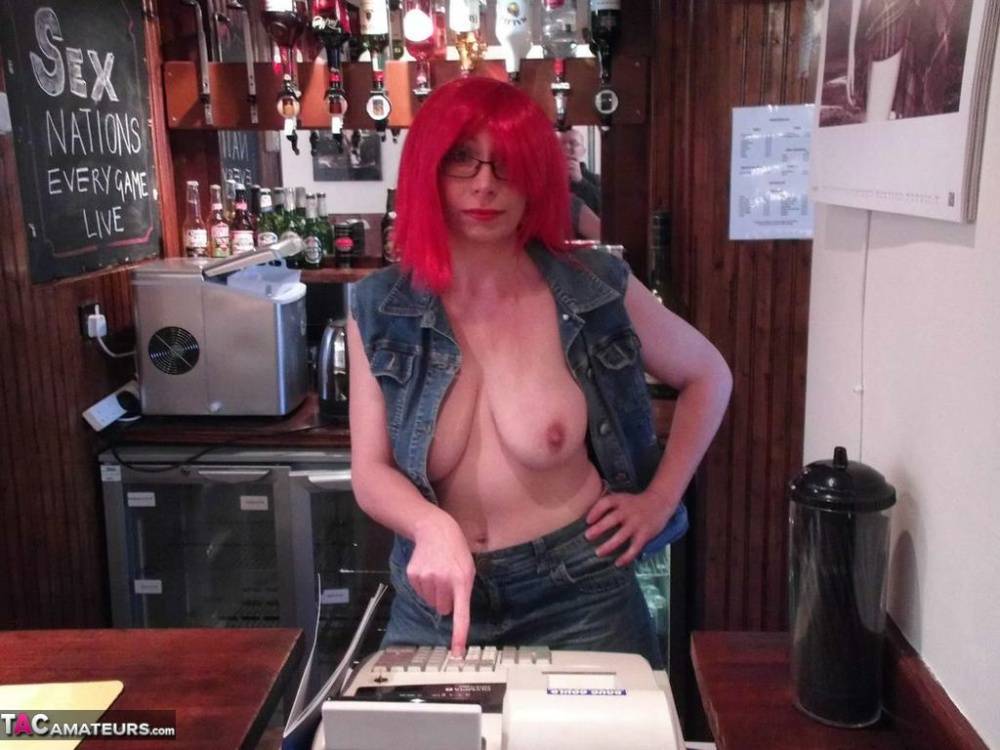 Redheaded amateur Barby Slut exposes her tits and ass while tending bar - #15