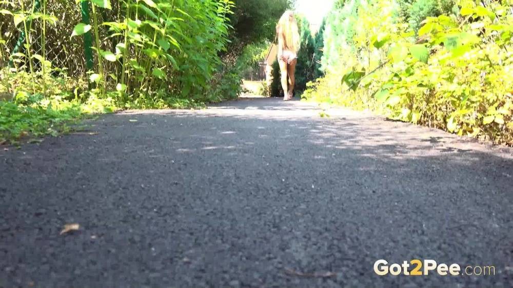 Blonde teen Daisy Lee takes a piss on a paved path through the woods - #2