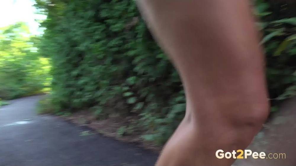 Blonde teen Daisy Lee takes a piss on a paved path through the woods - #15