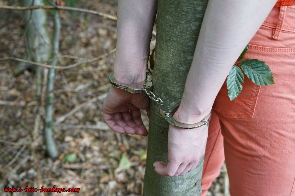 Clothed girl in canvas sneakers finds herself handcuffed to a tree in woods - #15