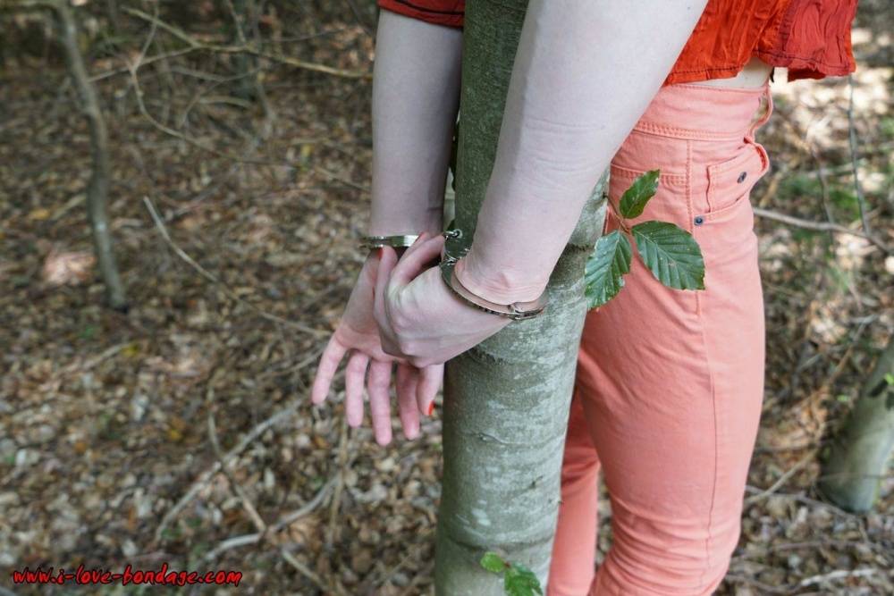 Clothed girl in canvas sneakers finds herself handcuffed to a tree in woods - #5