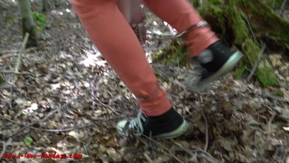 Clothed girl in canvas sneakers finds herself handcuffed to a tree in woods - #12