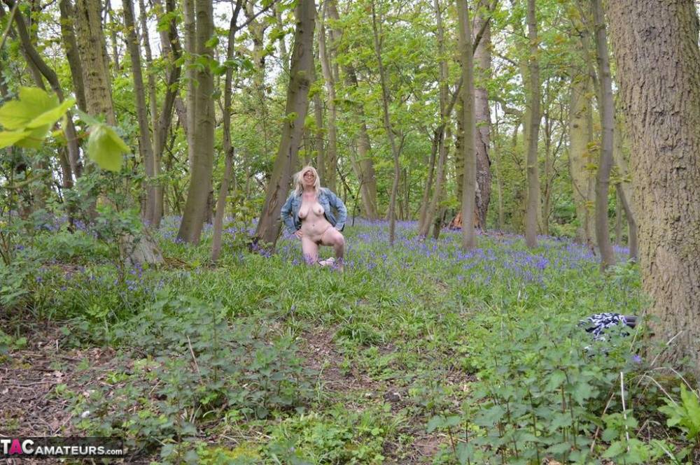 Blonde amateur Barby Slut gets naked in the woods amongst wild flowers - #7