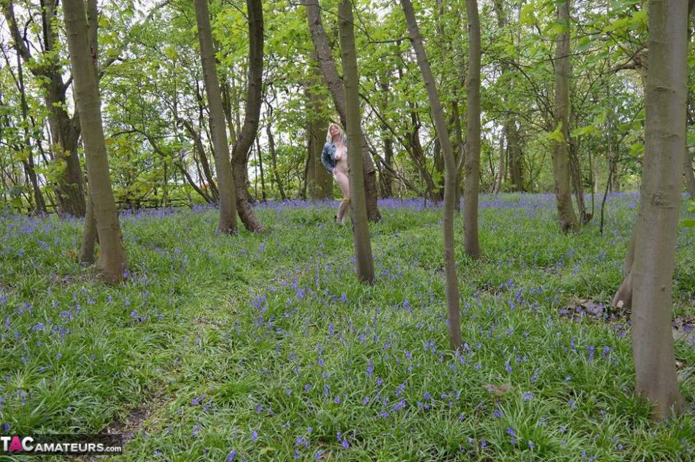 Blonde amateur Barby Slut gets naked in the woods amongst wild flowers - #16