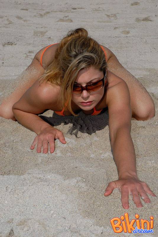 Hot beach beauty Amber in skimpy bikini poses on her knees in the sand - #7