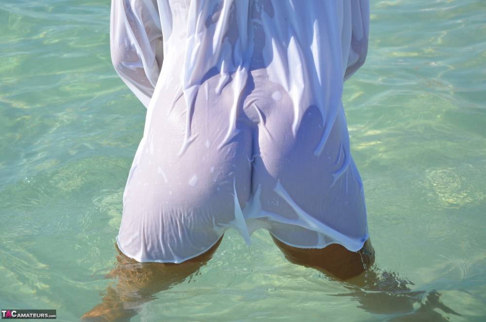 Blonde amateur Sweet Susi steps into the ocean while naked in a white shirt - #5