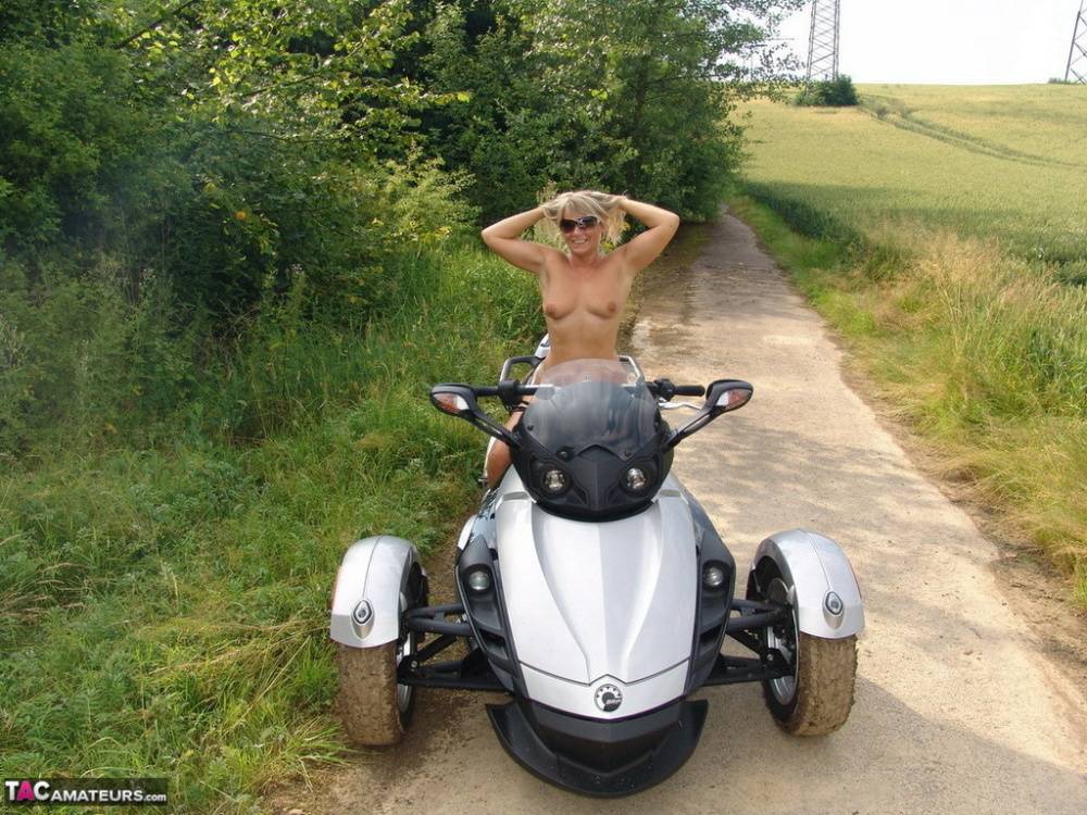 Middle-aged blonde Sweet Susi rides a three wheeled motorcycle while naked - #5