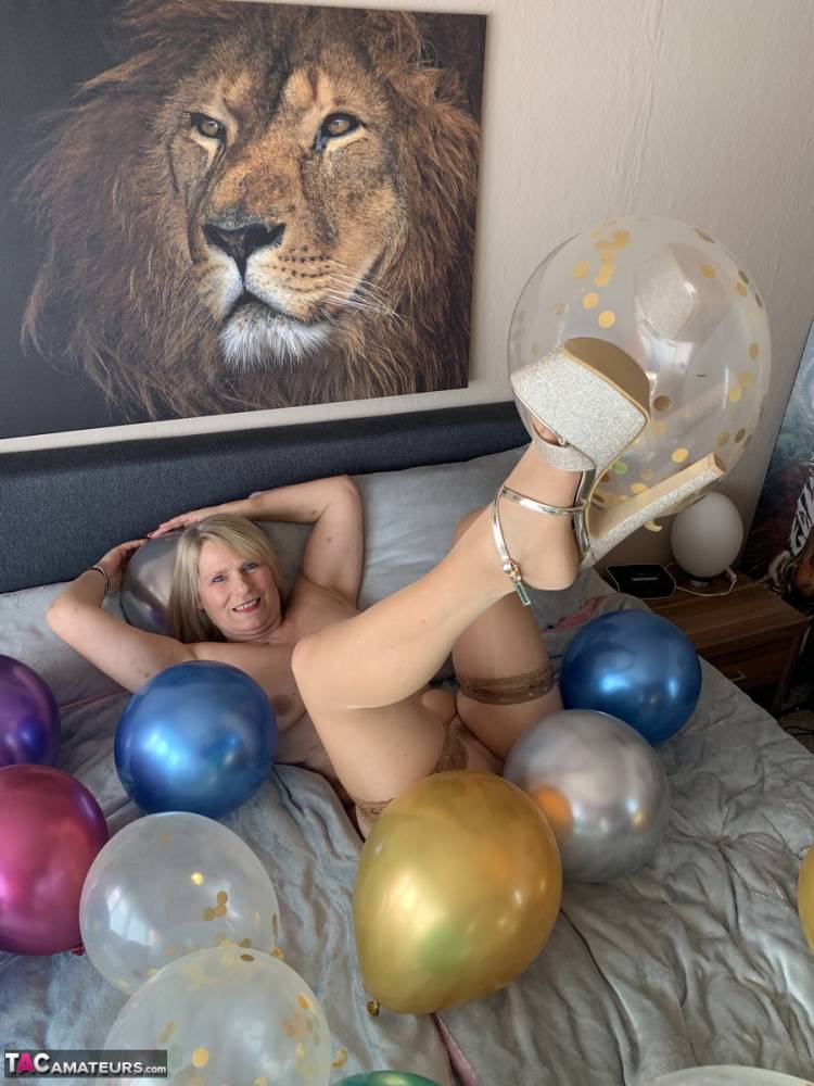 Middle-aged blonde Sweet Susi gets naked on her bed amid balloons - #8