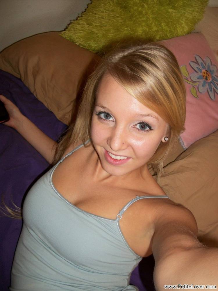 Cute teen girl with blonde hair displays her hairless pussy on her bed - #1