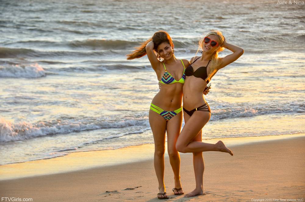 Teen lesbians in bikinis flash their tits and asses at the beach - #10