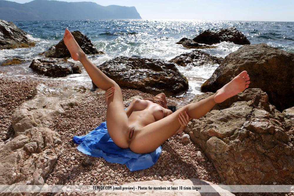 Totally naked teen Nadina L strikes great poses at the sea in incoming surf - #12