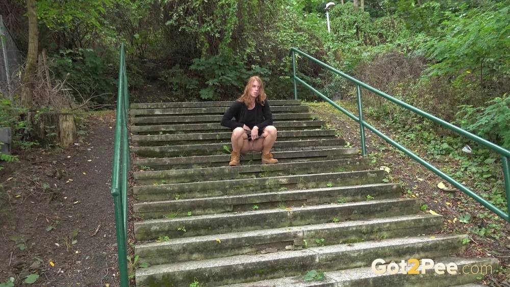 Natural redhead Chrissy Fox squats for a pee on a set of public steps - #14
