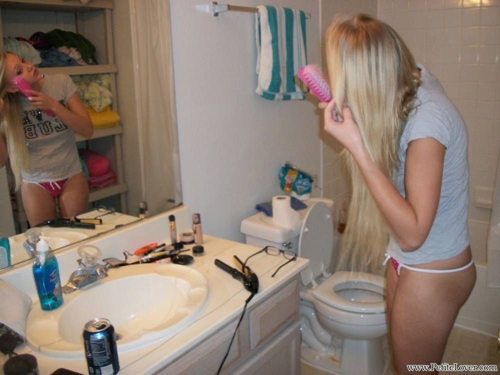 Blonde amateur Elle brushes her hair in glasses and thong while in a bathroom - #4