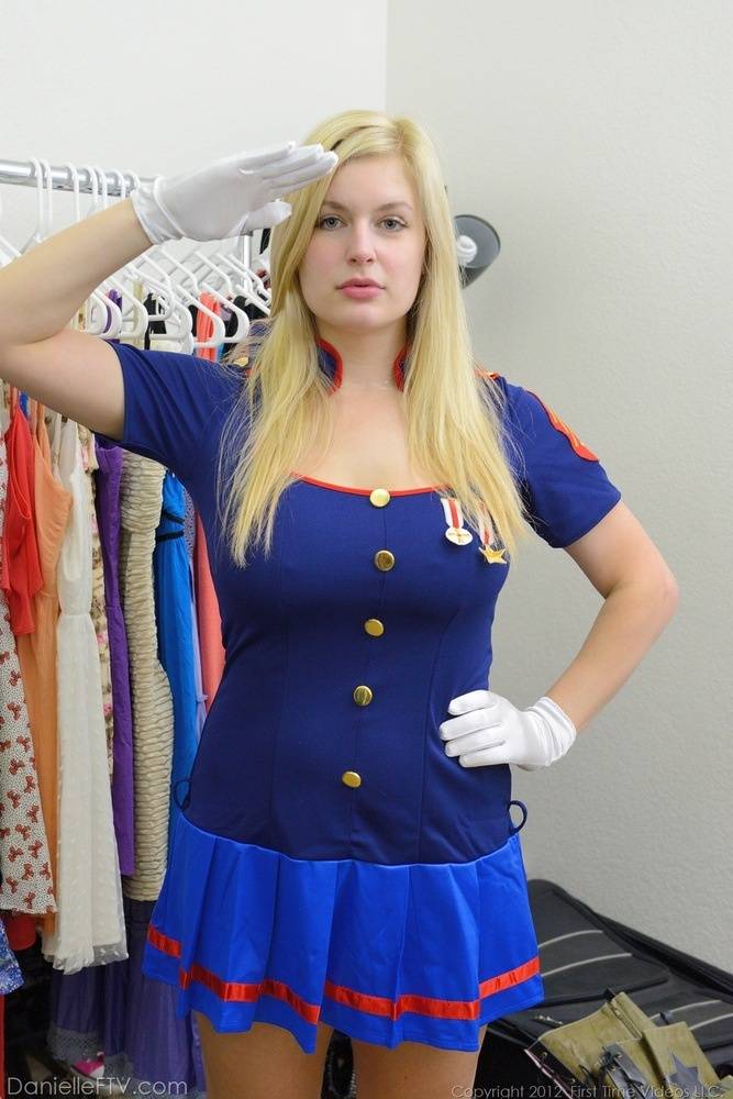 Busty blonde Danielle flashes her big tits and bald pussy in the uniform shop - #1