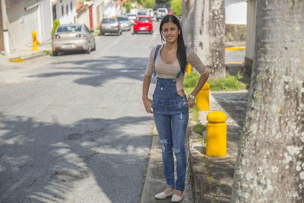 Clothed brunette teen Denisse Gomez shows off her pretty face in jean overalls - #9