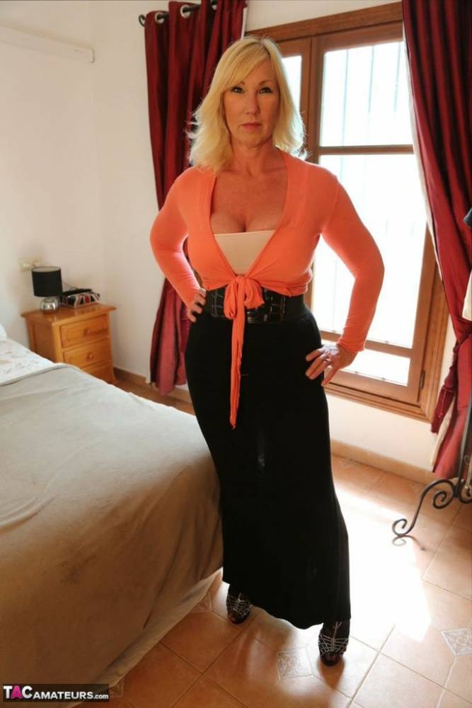Sexy older blonde Melody strips to bra and long skirt in high heels on bed - #7