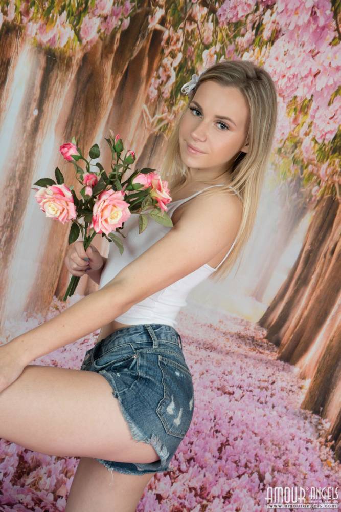 Young looking girl puts down a bunch of flowers before getting totally naked - #13