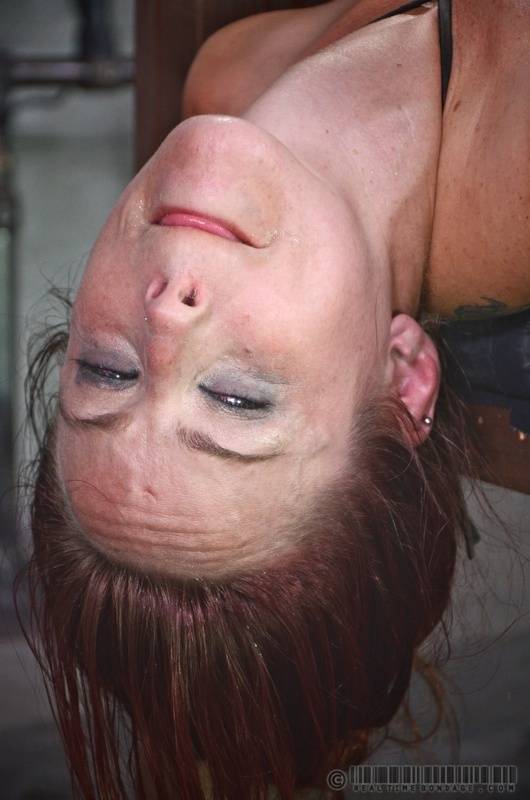 Young redhead Bella Rossi is completely humiliated while restrained to a rack - #1