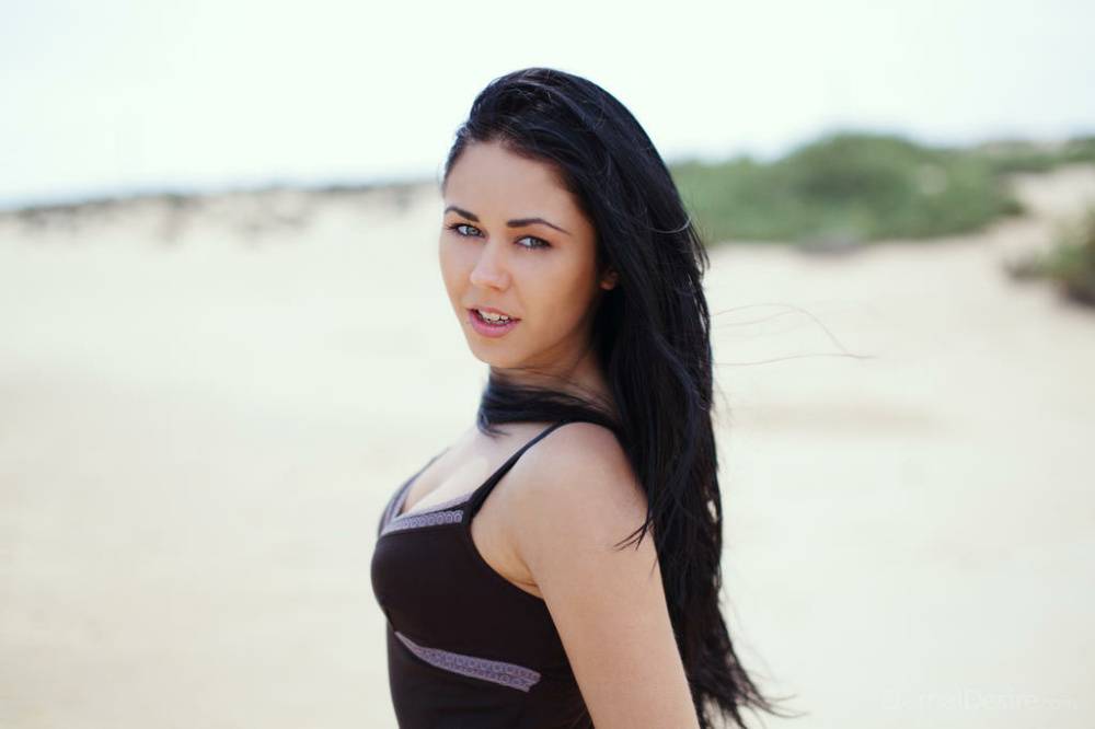 White teen with black hair dresses herself after modeling naked on a beach - #11