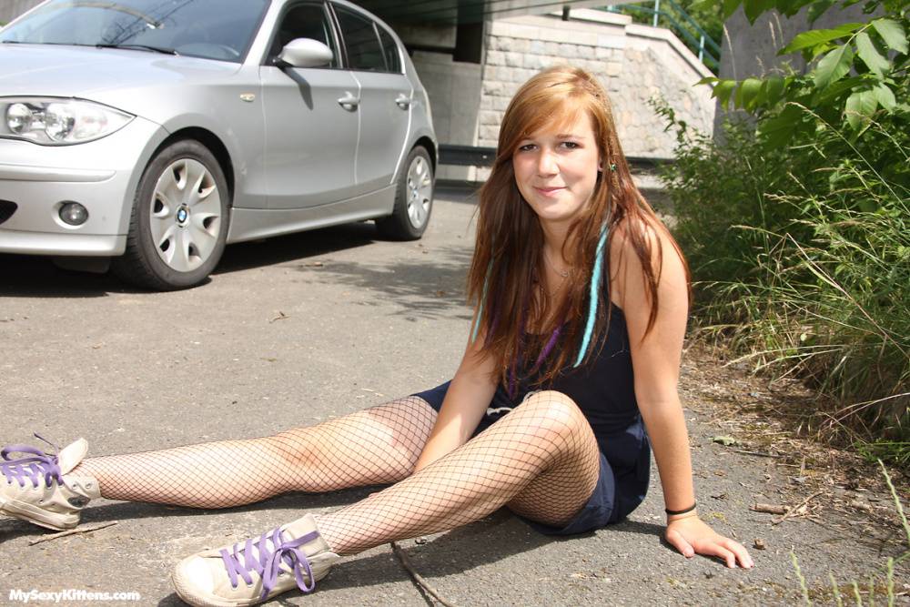 Nice teen rubs her horny pussy after taking off fishnet hose in the driveway - #6