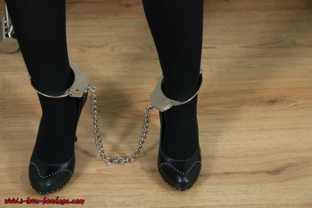 Fully clothed blonde is fastened to a wall with chains in handcuffs - #11