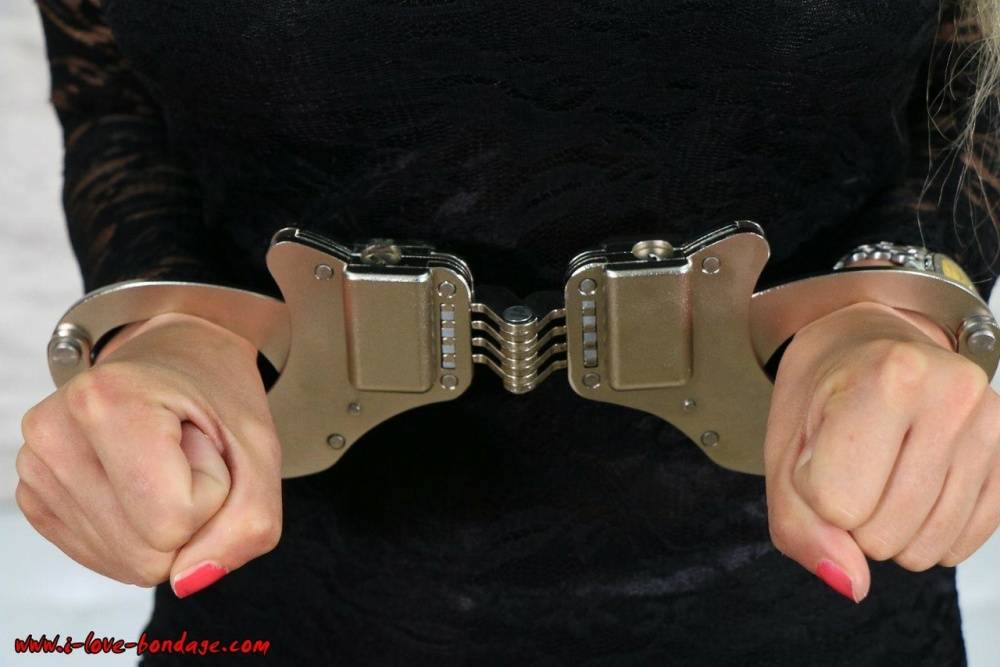 Fully clothed blonde is fastened to a wall with chains in handcuffs - #5