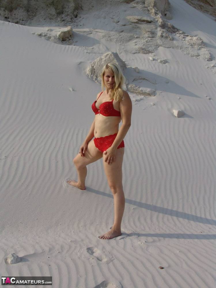 Blonde amateur Sweet Susi gets totally naked on a sandy bank by herself - #10
