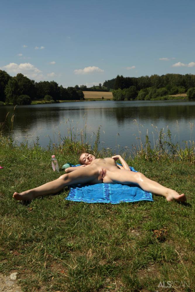 Tiny teen pegs her pink twat while naked on a towel by a river - #12