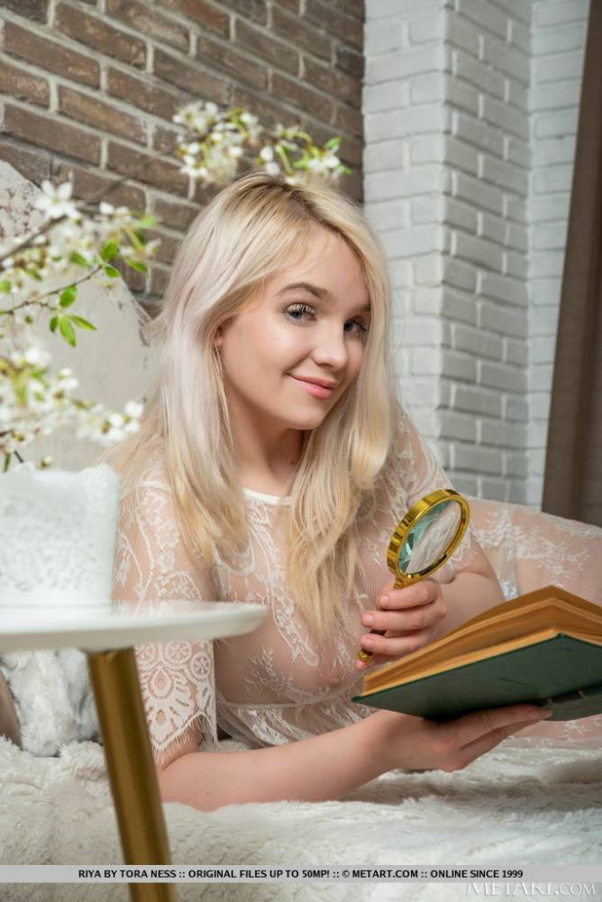Young looking blonde Riya gets naked in her bedroom while reading a book - #13