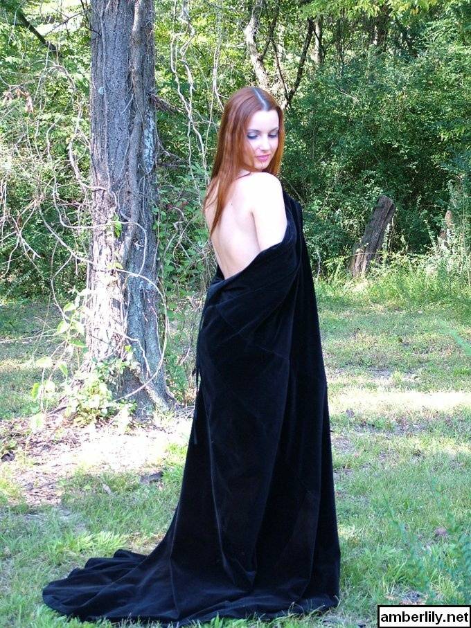 Redhead amateur Amber Lily models nude in a forest draped in a black cape - #10